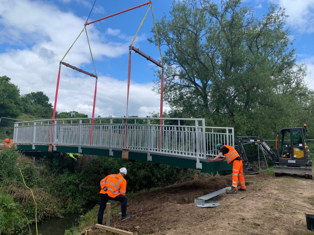 Weston Farm footbridge under construction with two workmen